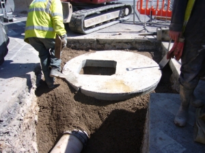 The last manhole cover in place, junction Bridge/Blesdon Rds