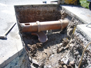Overflow pipe being connected to main sewer, junction Bridge/Bleadon  Roads